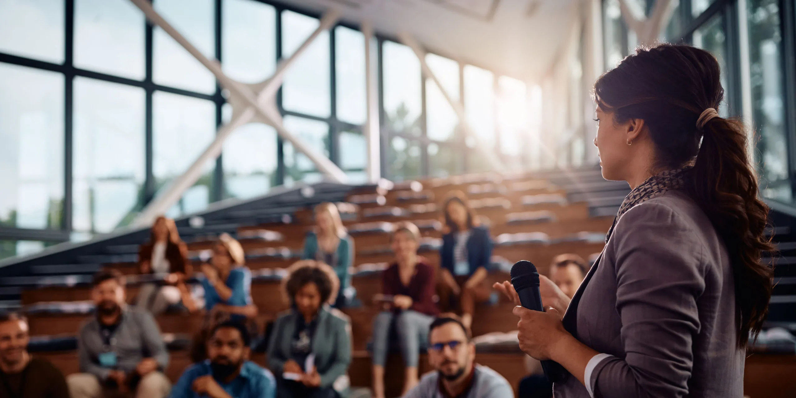 Deister Software professional gives a technology talk to a group of attendees inside a corporate center, sharing knowledge about business solutions and digital innovation.